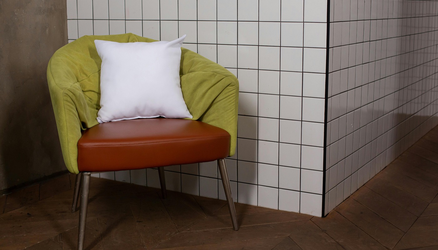 Fauteuil et coussin Forma mis en scène dans un intérieur carrelé